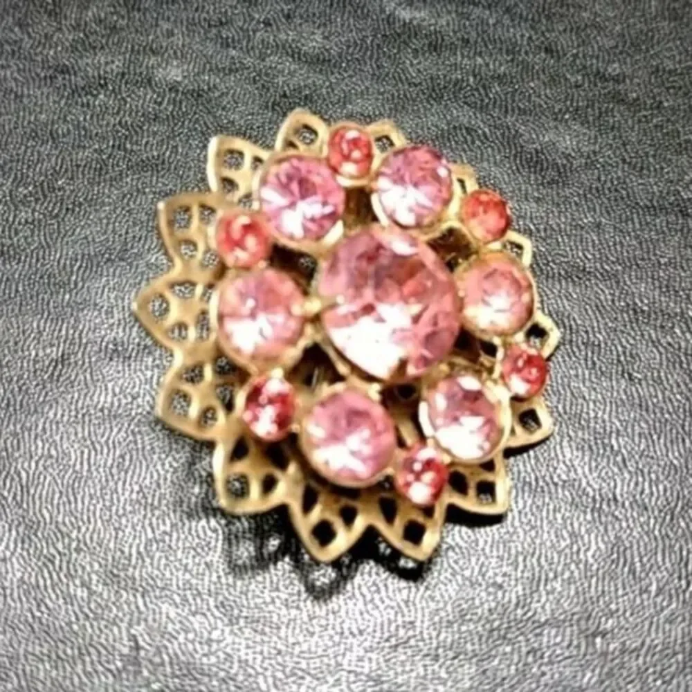 Gold tone flower pin with pink stones brooch